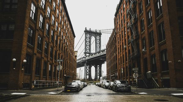 The Manhattan Bridge seen between the brick buildings of Washington Street, New York